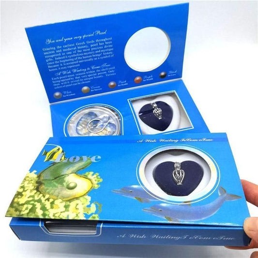 Blue jewelry box with a necklace and pendant inside, held by a hand.